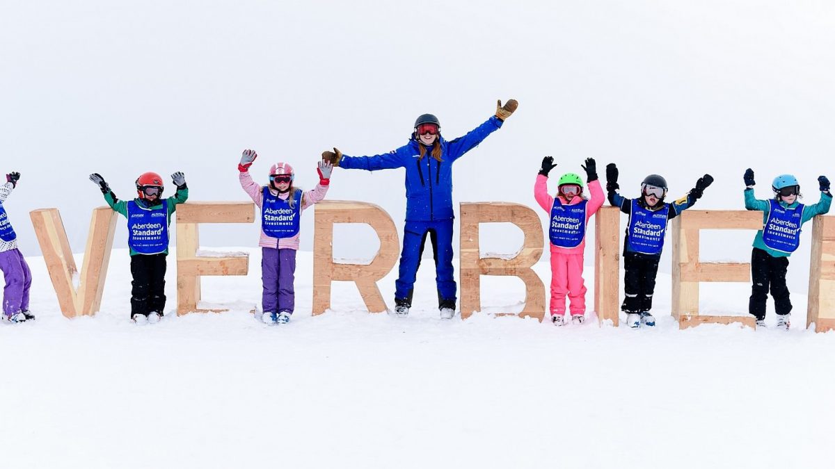 Verbier sign with instructors and kids in snow