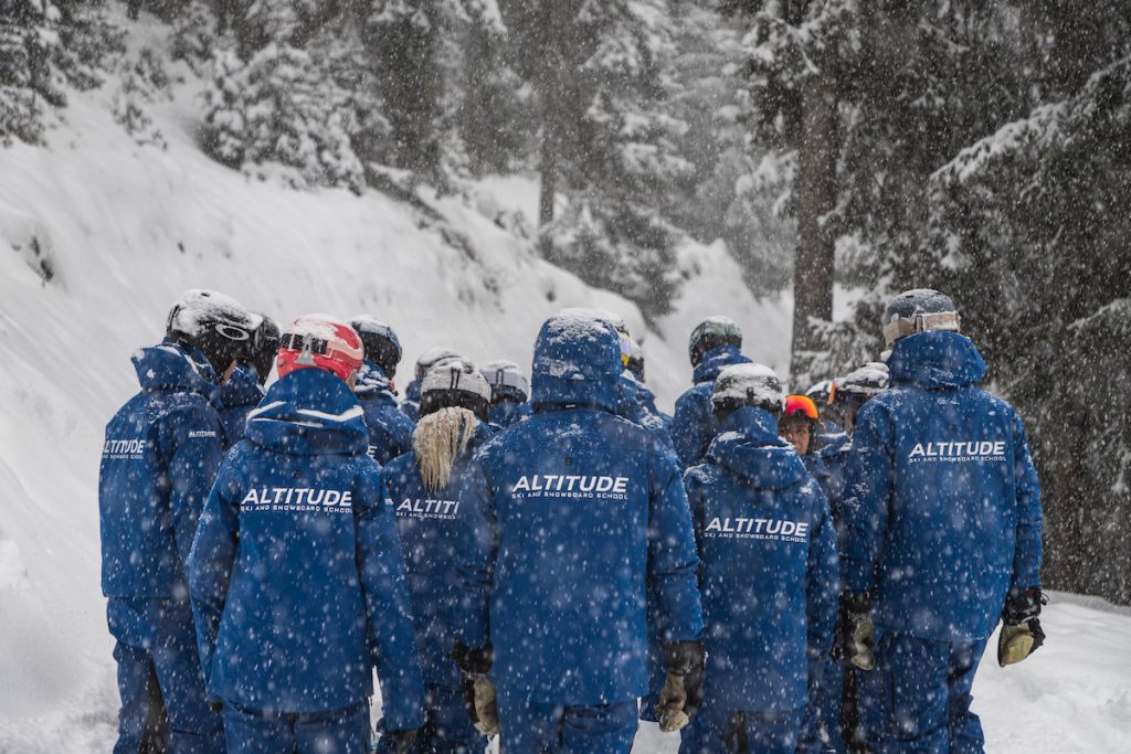 Group of ski instructors standing in snowy conditions - layering for skiing blog